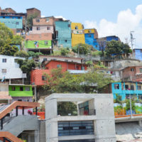 Multi coloured houses built into a hill