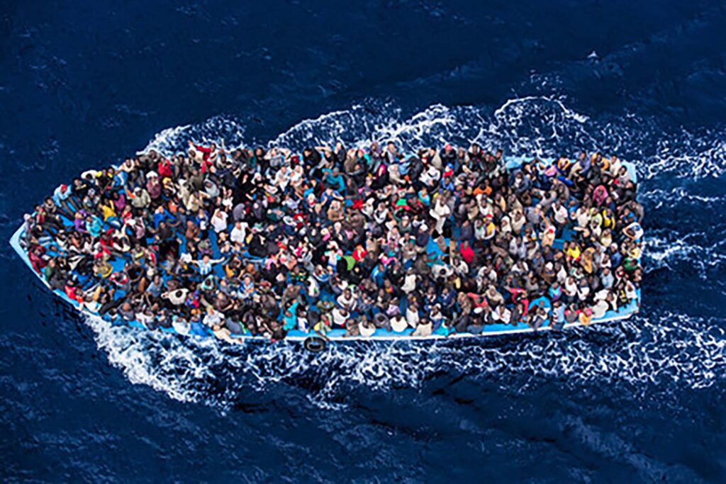 Rescued asylum seekers crowded on a boat on the Mediterranean Sea.