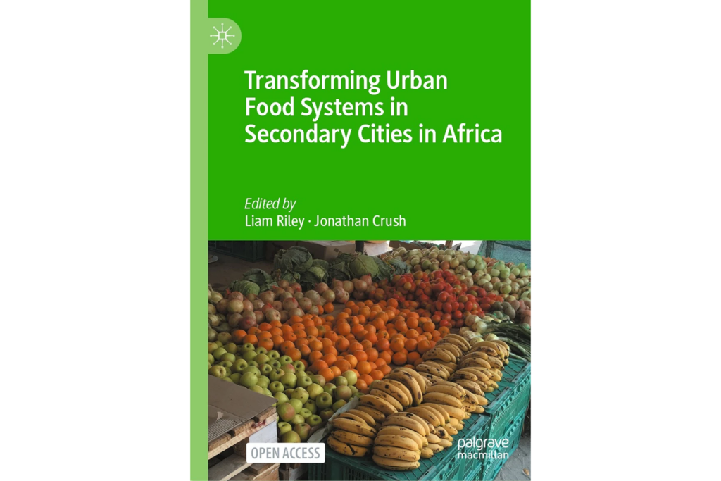 Transforming Urban Food Systems in Secondary Cities in Africa book title in white lettering on a green background with an image of vegetables at a market stall under the title.
