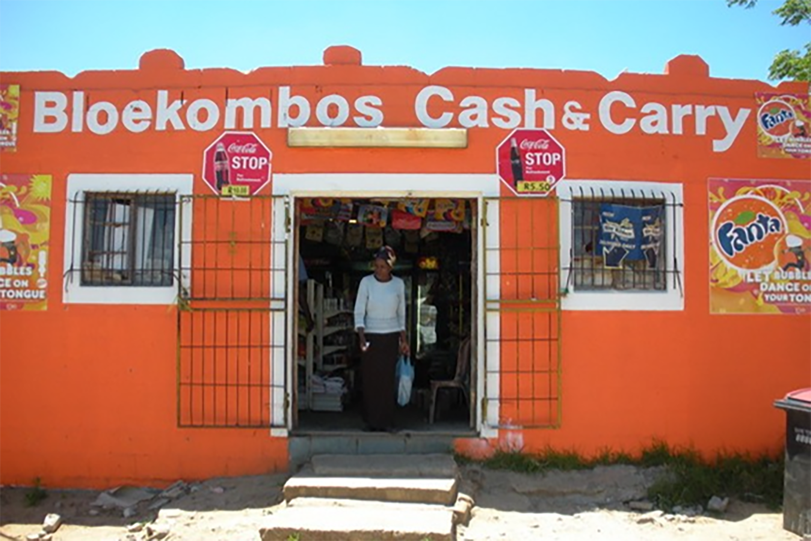 Bloekombos Cash and Carry store. Woman standing in the doorway.